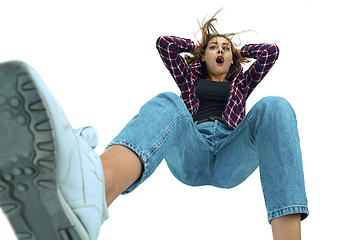 Image showing A second before falling - young girl falling down with bright emotions and expression