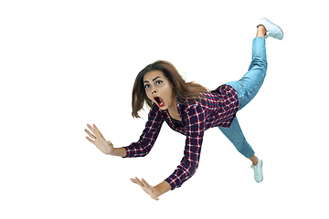 Image showing A second before falling - young girl falling down with bright emotions and expression