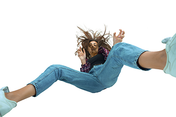 Image showing A second before falling - young girl falling down with bright emotions and expression