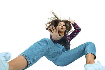 Image showing A second before falling - young girl falling down with bright emotions and expression