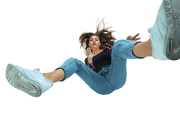 Image showing A second before falling - young girl falling down with bright emotions and expression