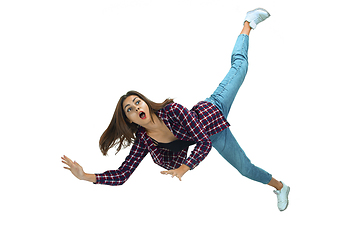 Image showing A second before falling - young girl falling down with bright emotions and expression