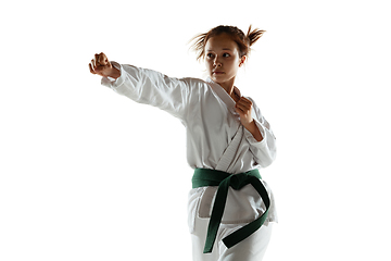 Image showing Confident junior in kimono practicing hand-to-hand combat, martial arts