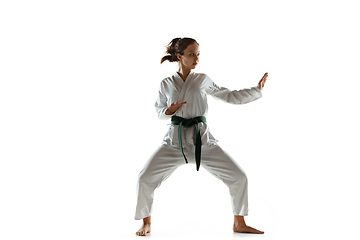 Image showing Confident junior in kimono practicing hand-to-hand combat, martial arts