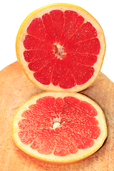 Image showing pieces of grapefruit on the board isolated