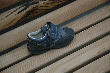 Image showing Blue shoe on bench