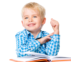 Image showing Little child play with book