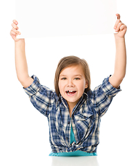 Image showing Little girl is holding a blank banner