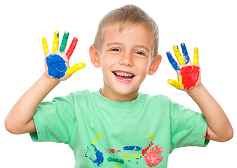 Image showing Portrait of a cute boy playing with paints