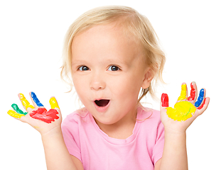 Image showing Portrait of a cute little girl playing with paints