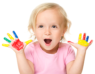 Image showing Portrait of a cute little girl playing with paints