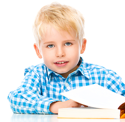 Image showing Little child play with book