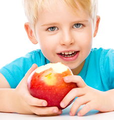 Image showing Portrait of a cute little boy with red apple