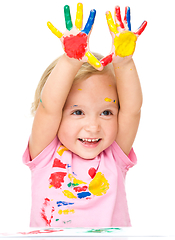 Image showing Portrait of a cute little girl playing with paints