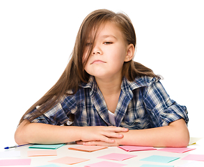 Image showing Girl is writing on color stickers