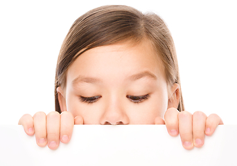 Image showing Little girl is looking from out blank board