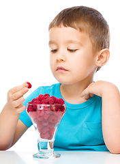 Image showing Little boy with raspberries