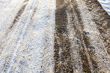 Image showing the snow-covered asphalt road close up