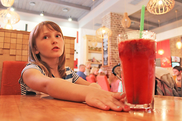 Image showing young girl drinks a lemonade