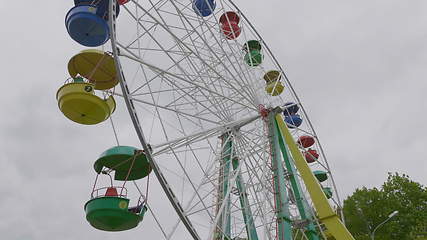 Image showing Underside view of a ferris wheel over blue sky.