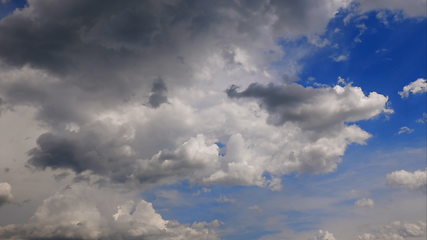 Image showing Time lapse Fluffy clouds float across the blue sky. UltraHD stock footage