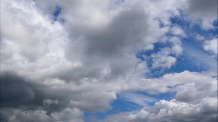 Image showing Time lapse Fluffy clouds float across the blue sky. UltraHD stock footage