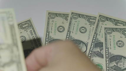 Image showing Man counting money of one thousand US dollars. UltraHD stock footage