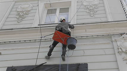 Image showing MOSCOW - JUNE 7: Climber spends repair work on a multi-storey building height on June 7, 2017 in Moscow, Russia. UltraHD stock footage