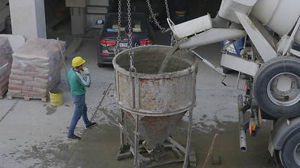 Image showing MOSCOW - AUGUST 26: Concrete mixer with is with poured cement slurry into the tank. on August 26, 2017 in Moscow, Russia