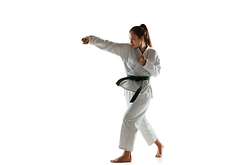 Image showing Confident junior in kimono practicing hand-to-hand combat, martial arts