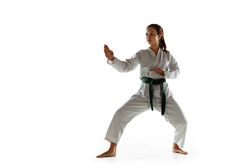 Image showing Confident junior in kimono practicing hand-to-hand combat, martial arts