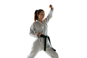 Image showing Confident junior in kimono practicing hand-to-hand combat, martial arts