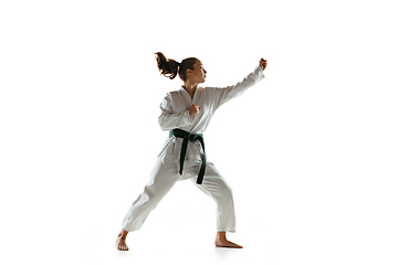Image showing Confident junior in kimono practicing hand-to-hand combat, martial arts