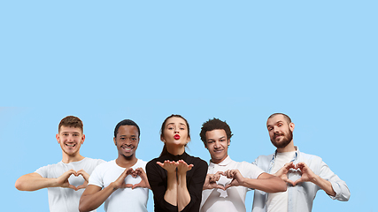 Image showing Portrait of multiethnic group of young people isolated on blue studio background, flyer, collage