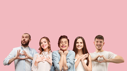 Image showing Portrait of multiethnic group of young people isolated on pink studio background, flyer, collage