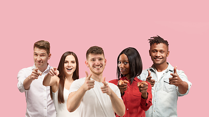 Image showing Portrait of multiethnic group of young people isolated on pink studio background, flyer, collage