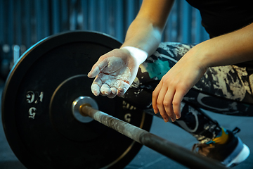 Image showing Caucasian teenage girl practicing in weightlifting in gym