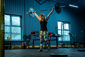 Image showing Caucasian teenage girl practicing in weightlifting in gym