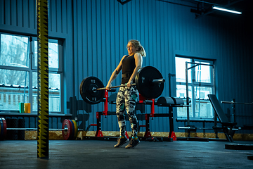 Image showing Caucasian teenage girl practicing in weightlifting in gym