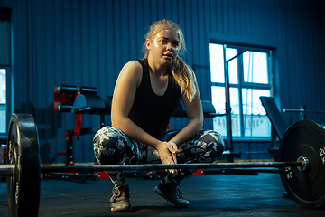 Image showing Caucasian teenage girl practicing in weightlifting in gym