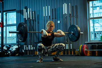 Image showing Caucasian teenage girl practicing in weightlifting in gym