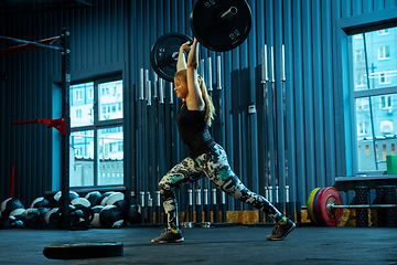 Image showing Caucasian teenage girl practicing in weightlifting in gym