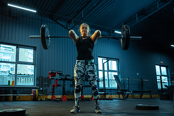 Image showing Caucasian teenage girl practicing in weightlifting in gym