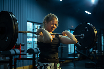 Image showing Caucasian teenage girl practicing in weightlifting in gym