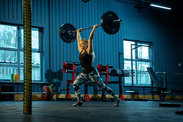 Image showing Caucasian teenage girl practicing in weightlifting in gym