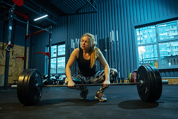 Image showing Caucasian teenage girl practicing in weightlifting in gym