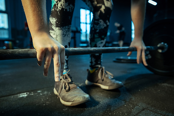 Image showing Caucasian teenage girl practicing in weightlifting in gym