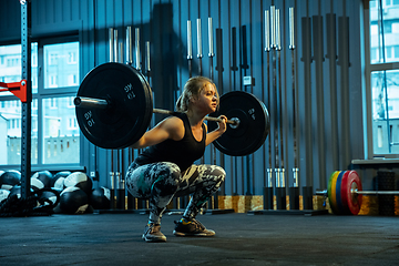 Image showing Caucasian teenage girl practicing in weightlifting in gym