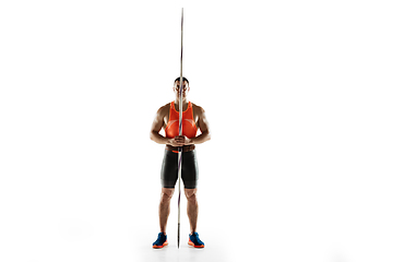 Image showing Male athlete practicing in throwing javelin isolated on white studio background