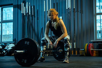 Image showing Caucasian teenage girl practicing in weightlifting in gym